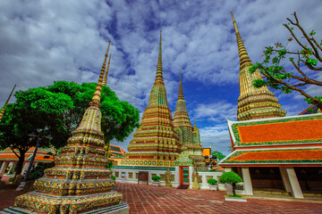 Fototapeta premium background of important religious attractions in Bangkok (Wat Phra Chetuphon (Wat Pho - reclining Buddha), a large pagoda and beautiful sculptural art give future generations to explore its history