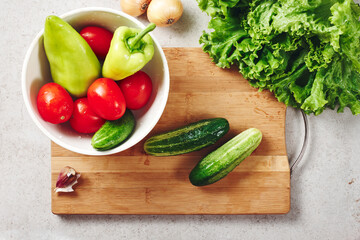 Fresh vegetables on a cutting board, salad ingredients.
