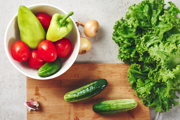Fresh vegetables on a cutting board, salad ingredients.