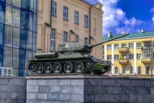 Kharkiv, Ukraine - July 20, 2020: A T-34-85 tank on display at M.F. Sumtsov Kharkiv Historical Museum, outdoors. Soviet medium tank of the World War II against  of city buildings on a summer day