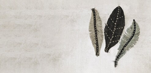 Making of bird feather from old jeans. Concept of old jeans reuse and natural resources preserving. 