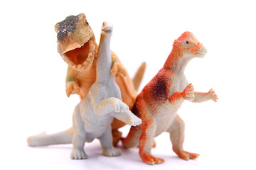Baby toys three dinosaurs close up on white background