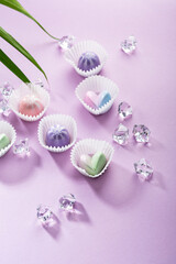 Obraz na płótnie Canvas Sweet chocolate candies on purple paper