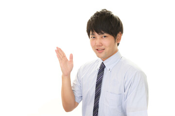 案内する笑顔のビジネスマン