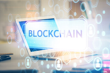 Multi exposure of blockchain theme hologram and table with computer background. Concept of bitcoin crypto currency.
