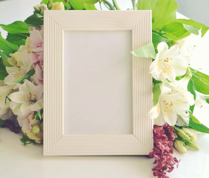 White wooden vertical frame and beautiful bunch of Peruvian lilies and light pink hydrangea. Wedding, Happy Birthday, 8 March, Valentine, Mother's Day card. Floral background. Space for text. 