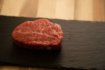 Fillet steak on the wooden round plate