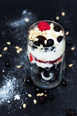 Raspberry, currant, ice cream and pine nuts in sweet dessert