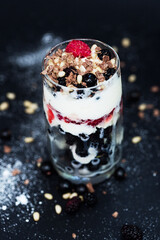 Raspberry, currant, ice cream in dessert on black background