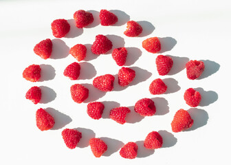
Raspberries on a white plate and with mint in the middle.