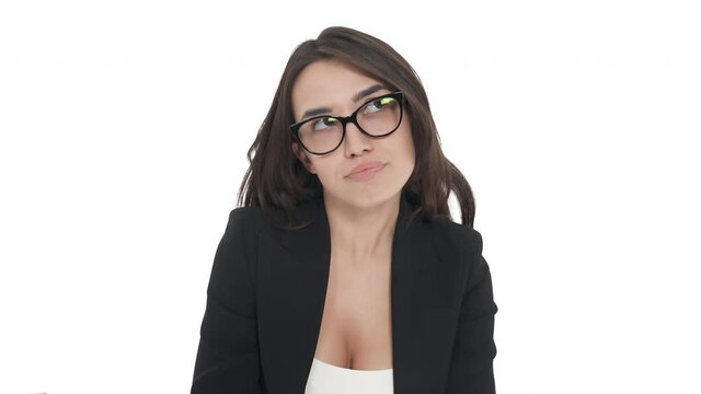 Portrait of Caucasian woman in glasses behaves like child, sticking her tongue out. Isolated on white background