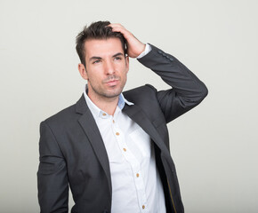 Portrait of young handsome Hispanic businessman in suit