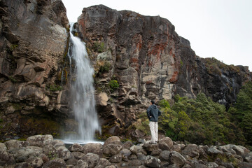 Fototapeta na wymiar Admiring Taranaki Falls in Tongariro National Park, New Zealand