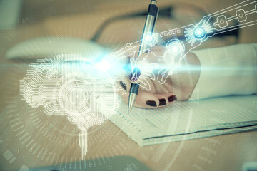 Multi exposure of woman's writing hand on background with brain hologram. Concept of brainstorming.