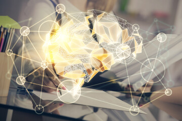 Multi exposure of woman's writing hand on background with brain hud. Concept of learning.