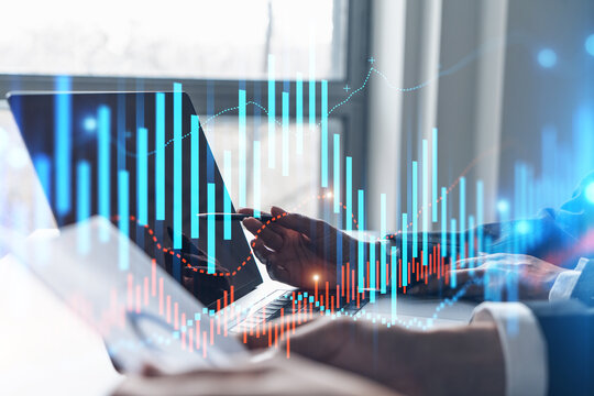 Two business people working together on stock market strategy. Try to analyze forex behavior. Financial graph hologram. Double exposure.