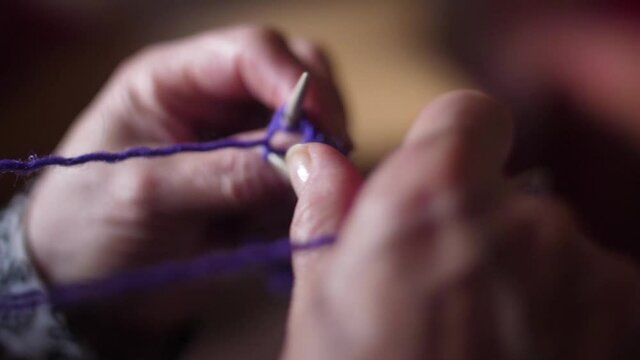 ederly woman hands Knitting doing crochet slow motion
