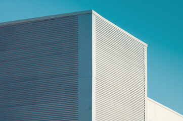 Fototapeta na wymiar Urban architecture. Close up of a modern office building facade with blue sky,