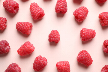 Fresh sweet ripe raspberries on pink background, flat lay
