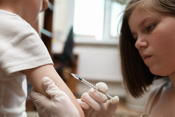Boy insulin injection in a shoulder. 