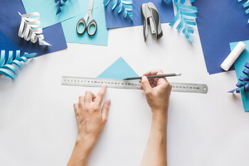 How to make paper beautiful Christmas toy snowflake to decorate room with children at home. Step by step instructions. Hands making winter DIY. Step 3. Step back from bend on 5 mm and draw line