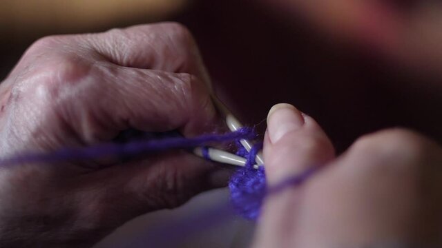 ederly woman hands Knitting doing crochet slow motion