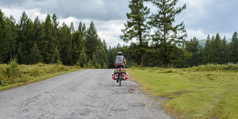 cyclist with bags rides a bicycle on the road. Active rest