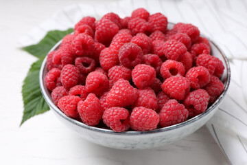 Delicious fresh ripe raspberries on white wooden table, closeup