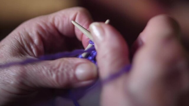 ederly woman hands Knitting doing crochet slow motion