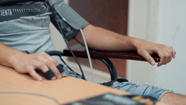 Man answering questions on a lie detector (polygraph).