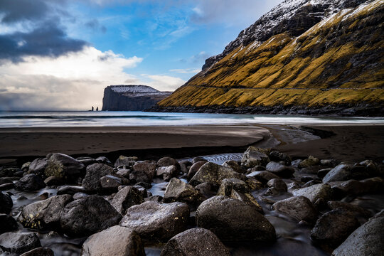 seascape with rocks in a small town near a mountain