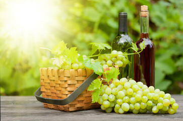 White and rose wine bottle and ripe grape