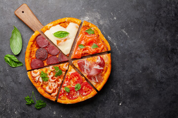 Tasty slices of different pizza