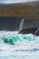 waterfall and waves in a stormy sea or ocean