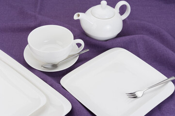 cup of tea and teapot on purple background