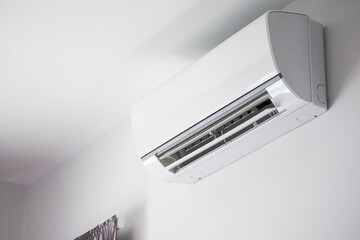 Air conditioner on white wall room interior background