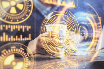 Technology theme hologram with man working on computer on background. High tech concept. Multi exposure.