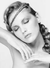 Naklejka premium Black and white portrait in high key tone female with creative hairdo braids