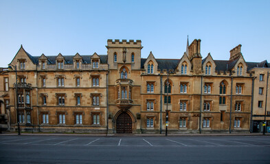 The Sheldonian Theatre and the statues around it, from Broad Street in Oxford with no people. Early in the morning. Oxford, England, UK.