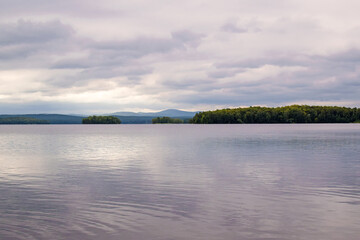 Landscape mountains lake forest. Beautiful purple sunset on Lake Uvildy, Southern Urals (Chelyabinsk region, Russia). Lake and forest. Selective focus.