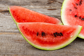 Fototapeta na wymiar Sliced fresh sweet watermelon on a rustic wooden table