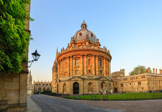 The Radcliffe Camera in Oxford at sunrise with no people around, early in the morning on a clear day with blue sky. Oxford, England, UK.