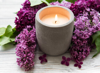 Fototapeta na wymiar Candle and lilac flowers
