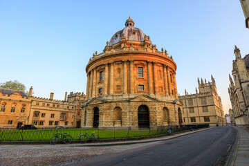 The Radcliffe Camera in Oxford at sunrise with no people around, early in the morning on a clear day with blue sky. Oxford, England, UK.