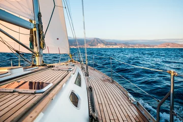 Rolgordijnen Sailboat and coastline in background - concept of travel and enjoy freedom on boat © simona