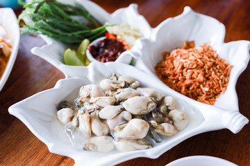 Fresh Oyster on ice serve with vegetables