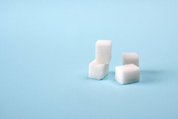Sugar cubes isolated on a blue background. Health concept. World Diabetes Day concept.