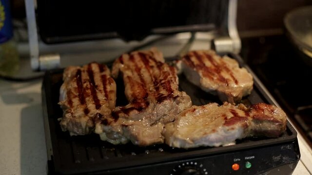 cooking meat on an electric grill