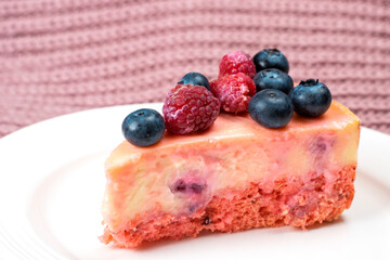 Cheesecake with berries on a white plate. Concept food photography. Sweets and berries. Copy space.