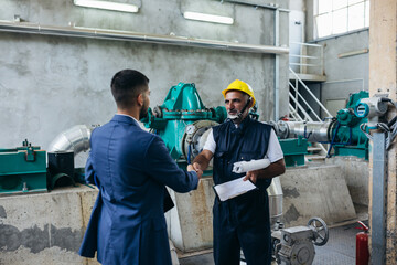 industry worker and businessman handshake